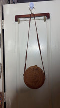 Round Woven Rattan Crossbody Bag with Floral Lining and Button-Loop Closure